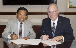 Cenon Jacob and President Harvey Kesselman sign gift agreement.