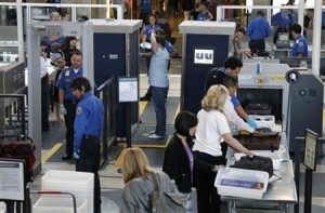 A man is screened with a backscatter x-ray machine as travellers go through a TSA security checkpoint in terminal 4 at LAX, Los Angeles International Airport, in Los Angeles May 2, 2011. REUTERS/Danny Moloshok