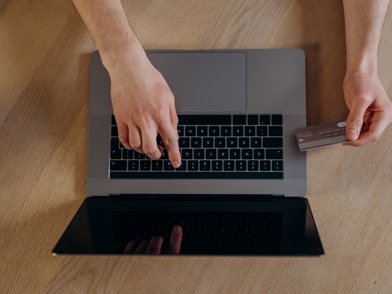 Person using a laptop to research debt forgiveness solution