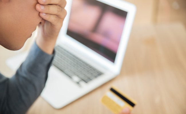 Laptop and credit card on a table