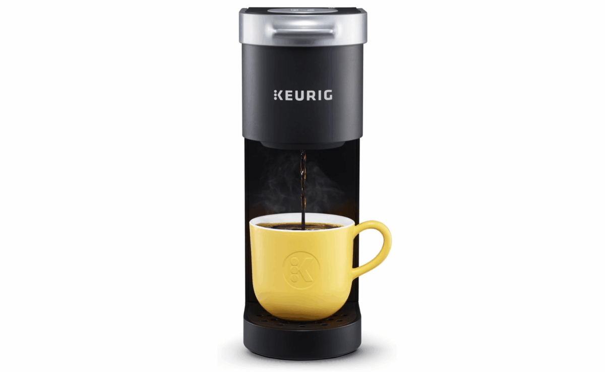 Keurig K-Mini single-serve coffee maker brewing into a yellow mug