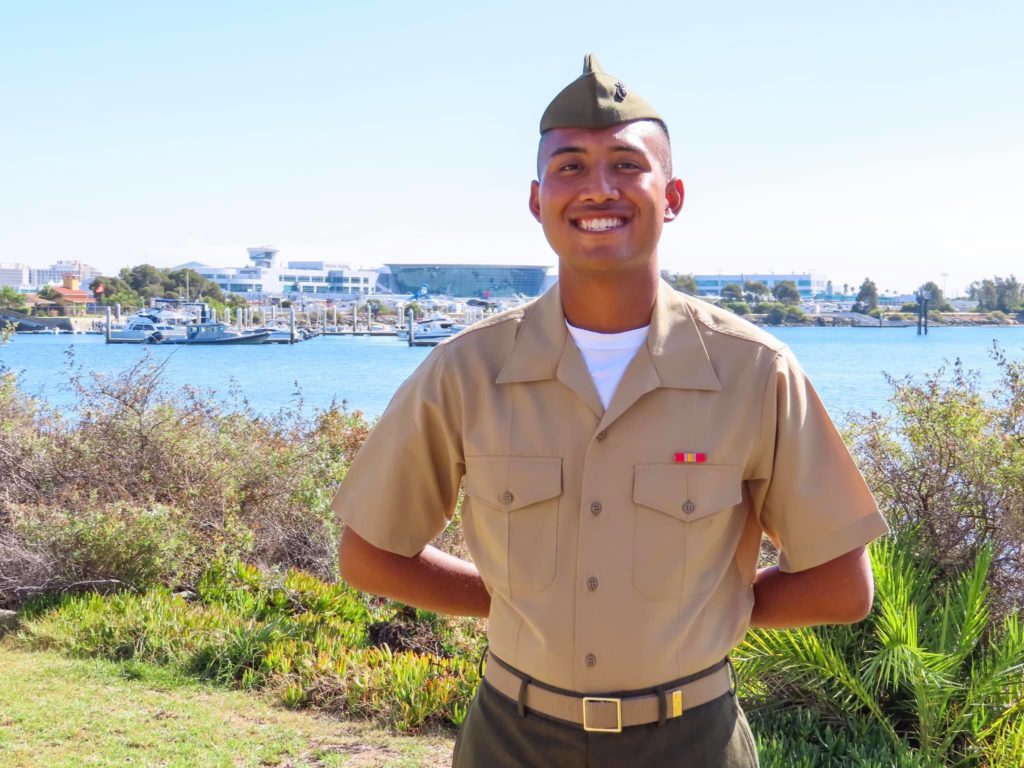 The late pfc Bryan Juan-Carlos Smiling in front of the camera with a body of water behind him