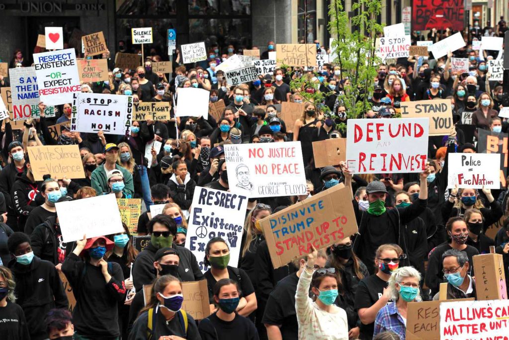 Protesters hold signs at a peaceful rally calling for an end to institutional racism and police brutality, Wednesday, June 3, 2020, in Portland, Maine. Credit: Robert F. Bukaty | AP  
