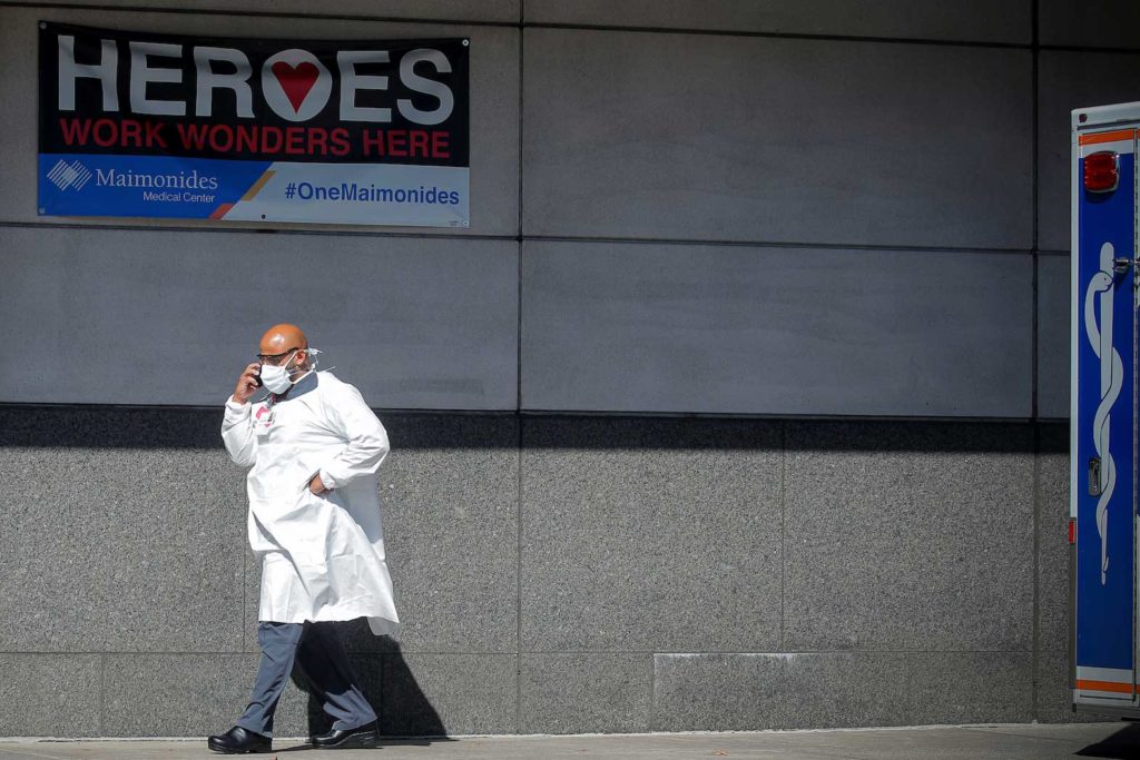 A doctor speaks on his phone outside the Emergency entrance to Maimonides Medical Center, as the spread of the coronavirus disease (COVID-19) continues, in the Borough Park neighborhood of Brooklyn, New York, U.S., October 14, 2020. REUTERS/Brendan McDermid