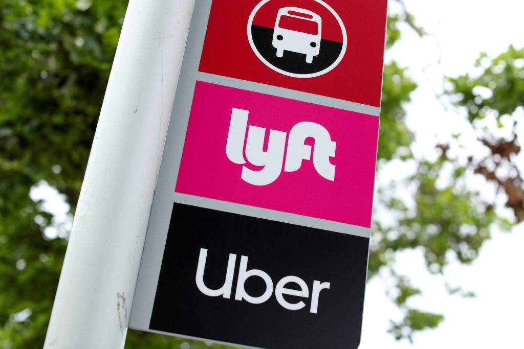  A sign marks a rendezvous location for Lyft and Uber users at San Diego State University in San Diego, California, U.S., May 13, 2020. REUTERS/Mike Blake/File Photo