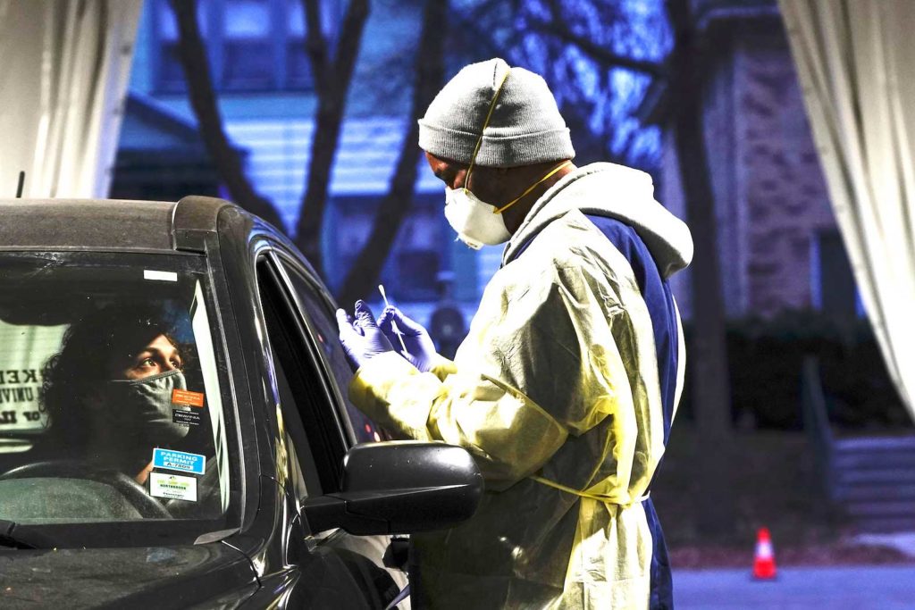Certified nursing assistant (CNA) Jermaine LeFlore prepares to take a patient's nasal swab at a drive-thru testing site outside the Southside Health Center as the coronavirus disease (COVID-19) outbreak continues in Milwaukee, Wisconsin, U.S., October 21, 2020. REUTERS/Bing Guan