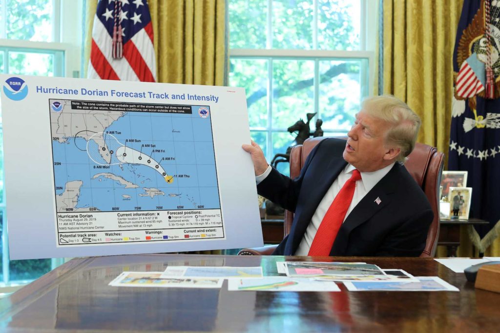 U.S. President Donald Trump looks at a tracking forecast map on Hurricane Dorian as he receives a status report on the storm in the Oval Office of the White House in Washington, U.S., September 4, 2019. REUTERS/Jonathan Ernst/File Photo