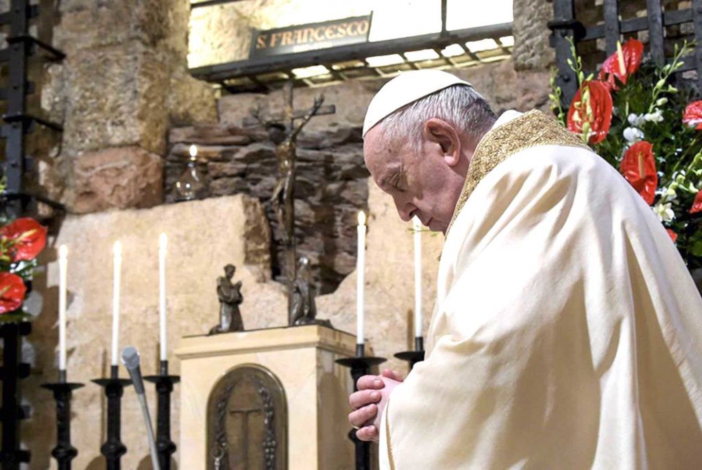 Pope Francis celebrates Mass at the tomb of St. Francis in the crypt of the Basilica of St. Francis Oct. 3 in Assisi, Italy. The pope signed his new encyclical, "Fratelli Tutti, on Fraternity and Social Friendship," at the end of the Mass. (CNS/Vatican Media)