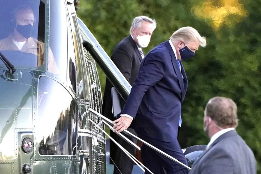 President Donald Trump arrives at Walter Reed National Military Medical Center, in Bethesda, Md., Friday, Oct. 2, 2020, on Marine One helicopter after he tested positive for Covid-19. White House chief of staff Mark Meadows is at second from left. (AP Photo/Jacquelyn Martin)
