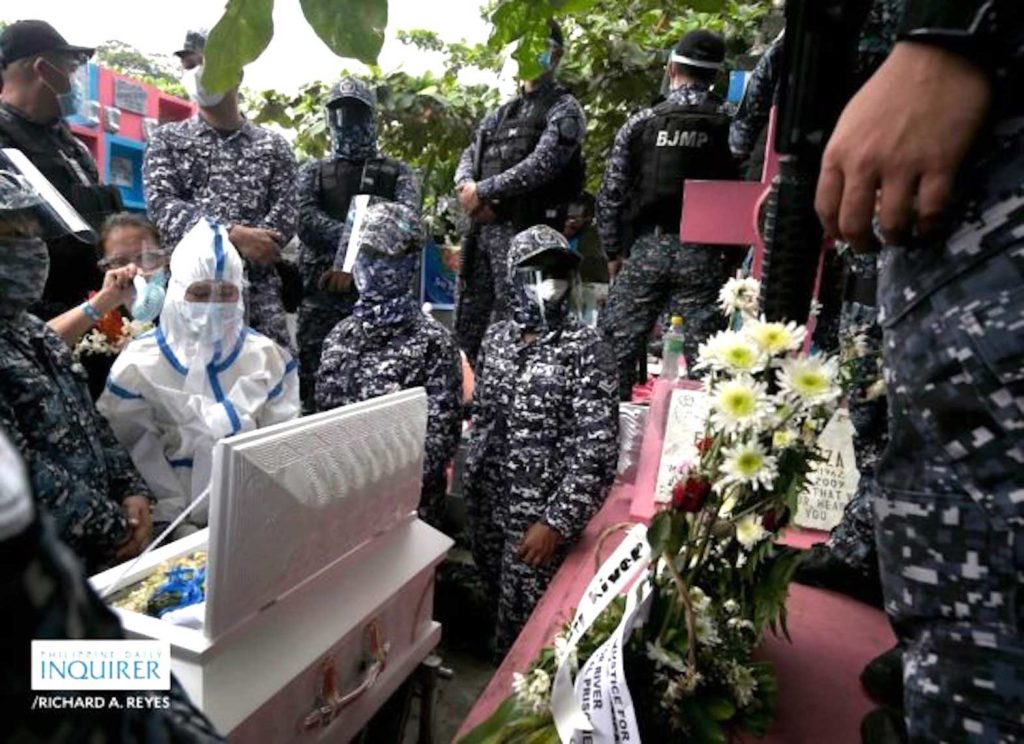 Heavily armed cops and soldiers surrounding Baby River's coffin and her political prisoner mother (in PPE). INQUIRER FILE