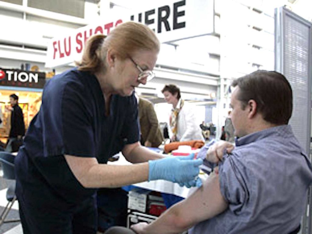 Man Getting Flu Shot. JEFF HAYNES/AFP