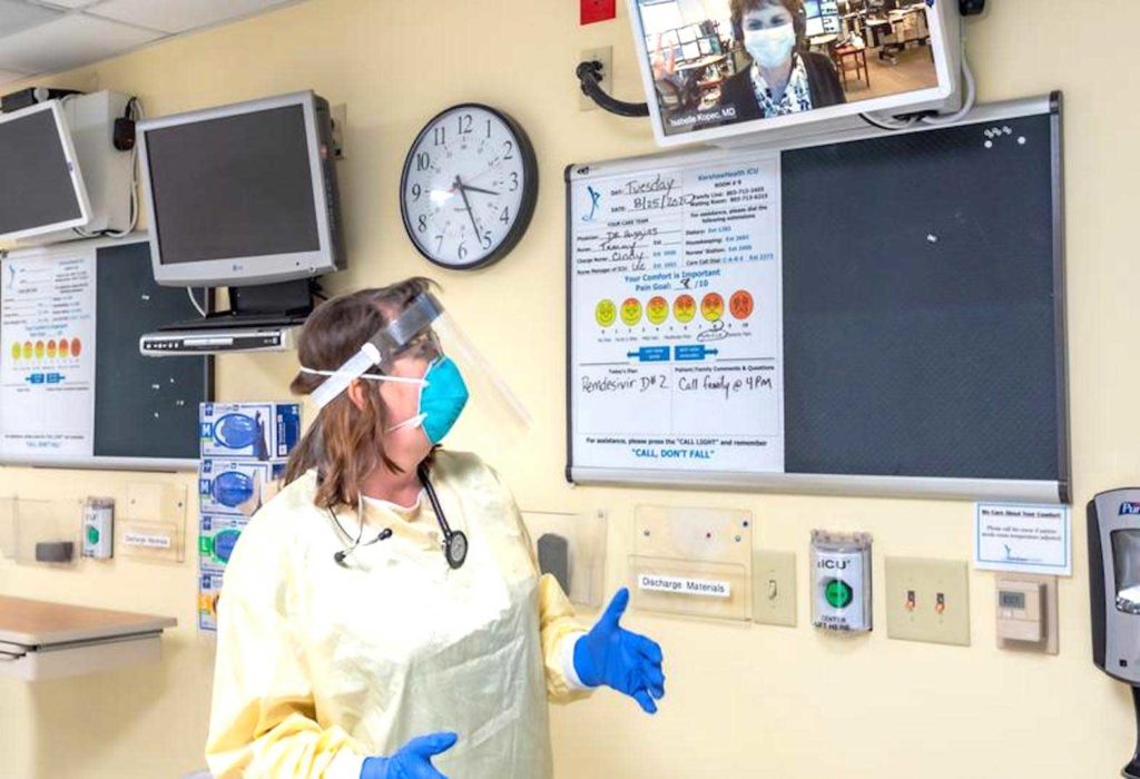 Tallulah Holmstrom, chief medical officer, wears a protective gear in her intensive-care unit and discusses the coronavirus disease (Covid -19) with Isabelle Kopec, critical-care physician in St. Louis, who monitors patients remotely across the United States for Advanced ICU Care, at KershawHealth hospital in Camden, South Carolina, U.S., August 25, 2020. Kathryn Van Aernum for KershawHealth/Handout via REUTERS