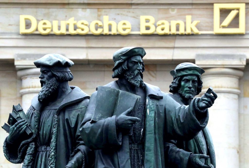   A statue is pictured next to the logo of Germany's Deutsche Bank in Frankfurt, Germany September 30, 2016. REUTERS/Kai Pfaffenbach