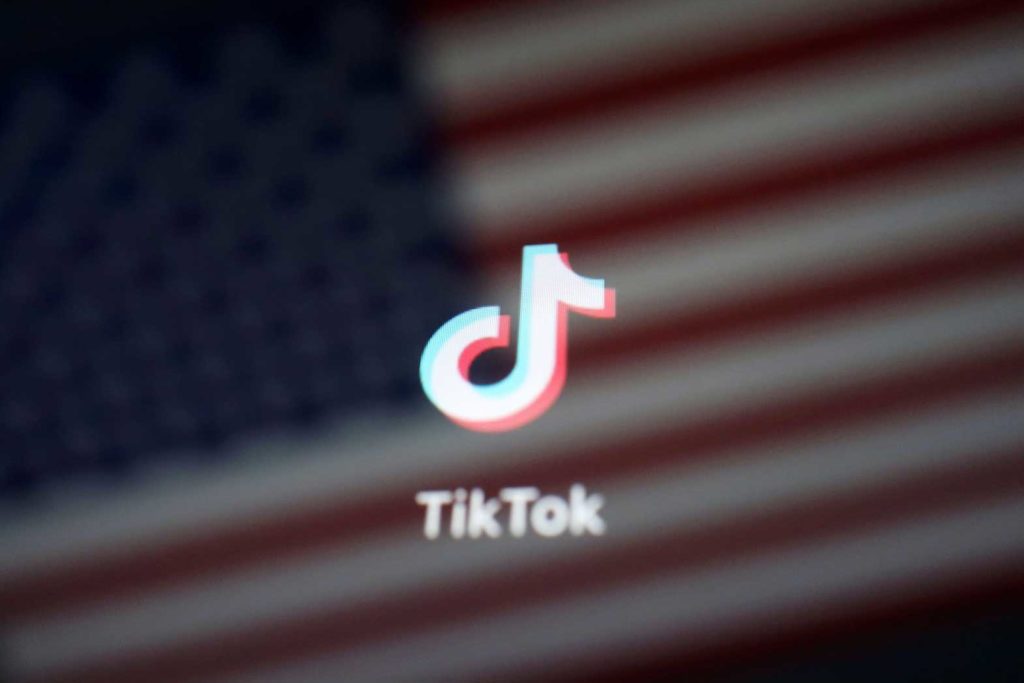 A reflection of the U.S. flag is seen on the sign of the TikTok app in this illustration picture taken September 19, 2020. REUTERS/Florence Lo