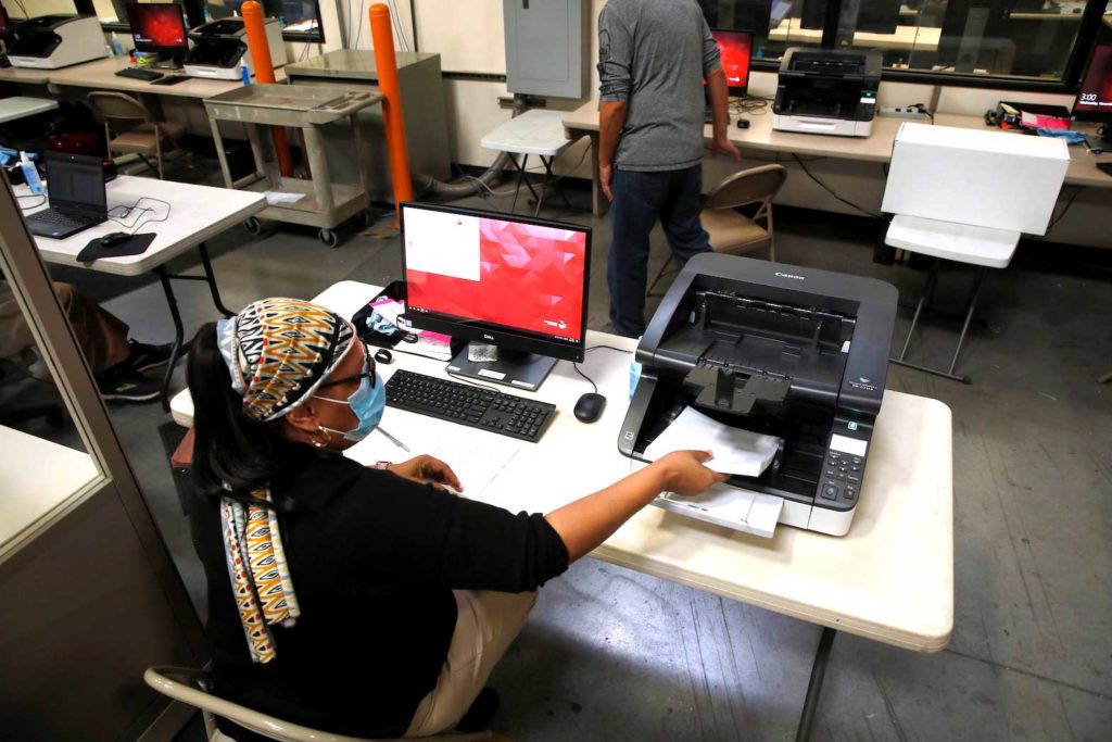 A county election worker tabulates ballots at the Clark County Election Center in North Las Vegas, Nevada, U.S. November 4, 2020. REUTERS/Steve Marcus