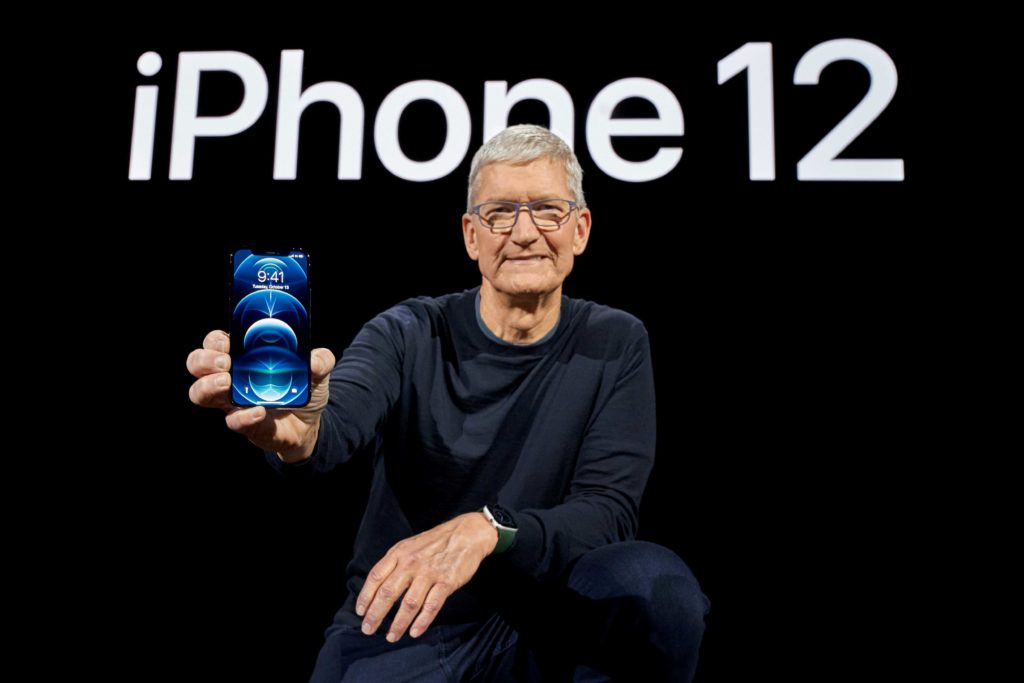  Apple CEO Tim Cook poses with the all-new iPhone 12 Pro at Apple Park in Cupertino, California, U.S. in a photo released October 13, 2020. Brooks Kraft/Apple Inc./Handout via REUTERS