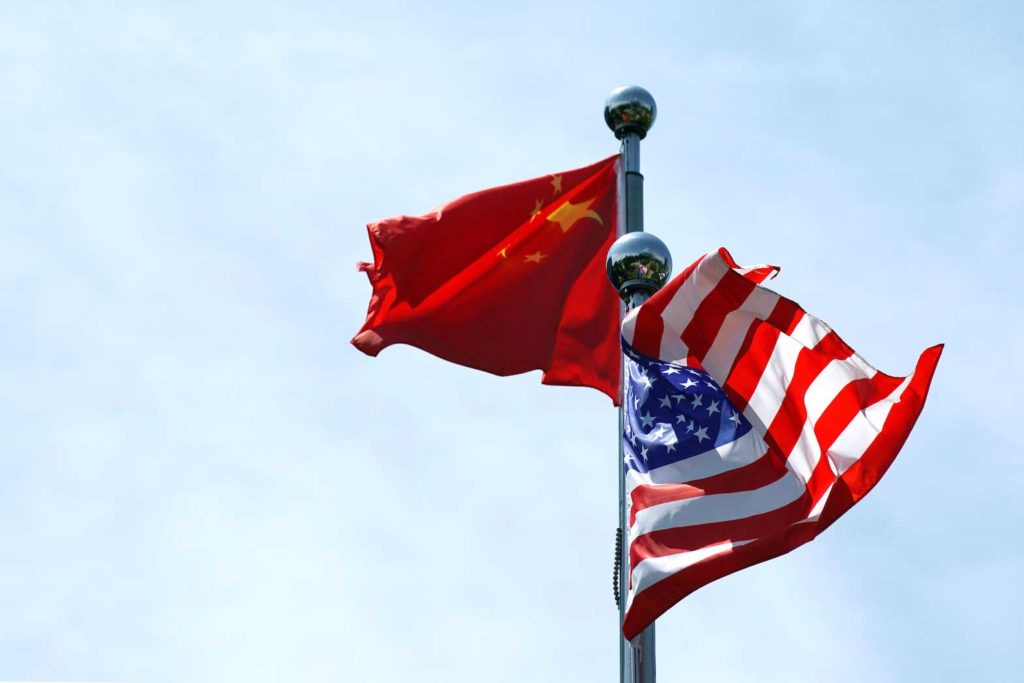Chinese and U.S. flags flutter near The Bund, before U.S. trade delegation meet their Chinese counterparts for talks in Shanghai, China July 30, 2019. REUTERS/Aly Song