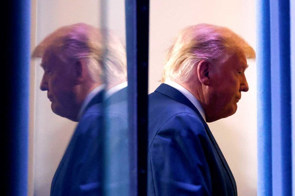 U.S. President Donald Trump is reflected as he departs after speaking about the 2020 U.S. presidential election results in the Brady Press Briefing Room at the White House in Washington, U.S., November 5, 2020. REUTERS/Carlos Barria/File Photo