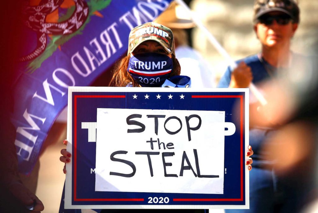   A supporter of U.S. President Donald Trump holds a sign during a “Stop the Steal” protest after the 2020 U.S. presidential election was called by the media for Democratic candidate Joe Biden, in front of the Arizona State Capitol in Phoenix, Arizona, U.S., November 7, 2020. REUTERS/Jim Urquhart