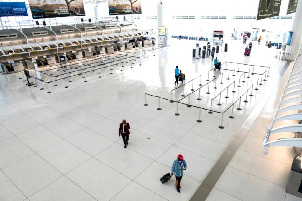  People walk around the terminal at the John F. Kennedy International Airport in New York, U.S., March 9, 2020. REUTERS/Eduardo Munoz/File Photo