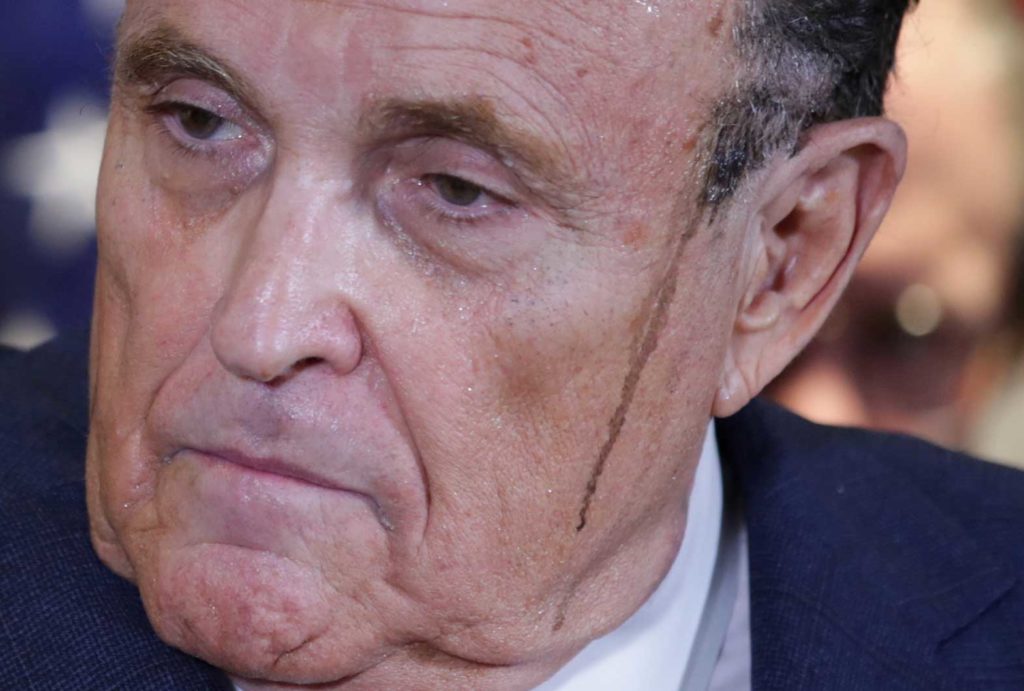 Sweat runs down the face of former New York City Mayor Rudy Giuliani, personal attorney to U.S. President Donald Trump, as he speaks about the 2020 U.S. presidential election results during a news conference at Republican National Committee headquarters in Washington, U.S., November 19, 2020. REUTERS/Jonathan Ernst