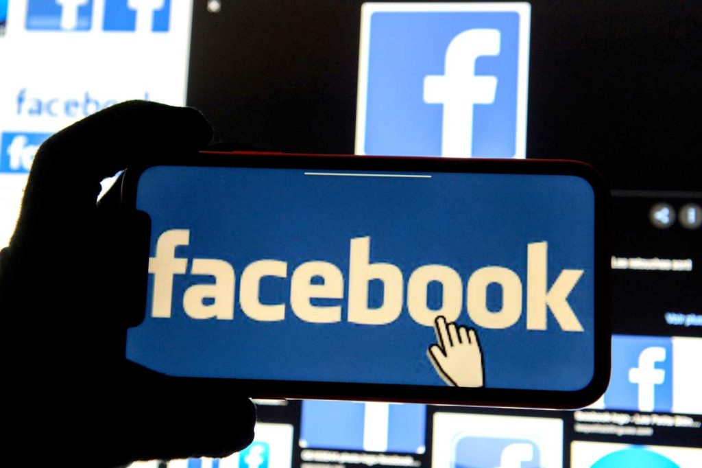 The Facebook logo is displayed on a mobile phone in this picture illustration taken December 2, 2019. REUTERS/Johanna Geron/Illustration