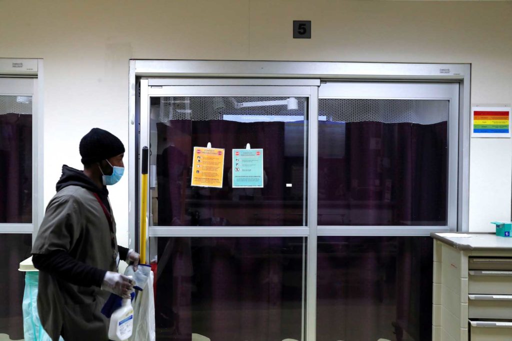 A housekeeper walks by the isolation room of a coronavirus disease (COVID-19) positive patient inside the emergency room bed at Roseland Community Hospital on the South Side of Chicago, Illinois, U.S., December 2, 2020. REUTERS/Shannon Stapleton/File Photo