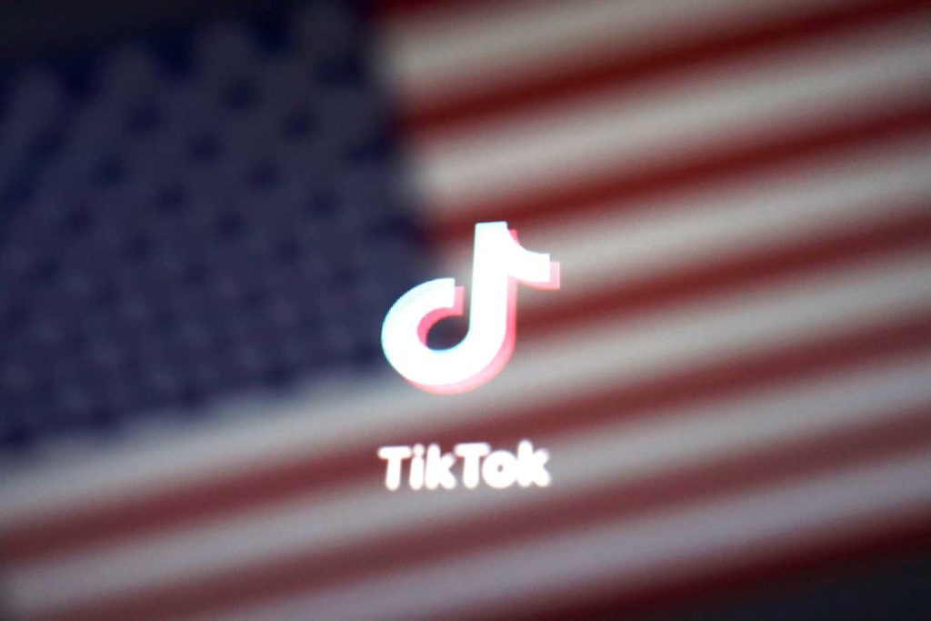  A reflection of the U.S. flag is seen on the sign of the TikTok app in this illustration picture taken September 19, 2020. REUTERS/Florence Lo/Illustration