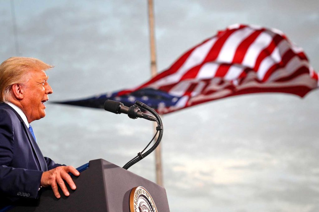 President Donald Trump speaks, with a flag behind him, during a campaign rally at Cecil Airport in Jacksonville, Florida, U.S., September 24, 2020. REUTERS/Tom Brenner/File Photo