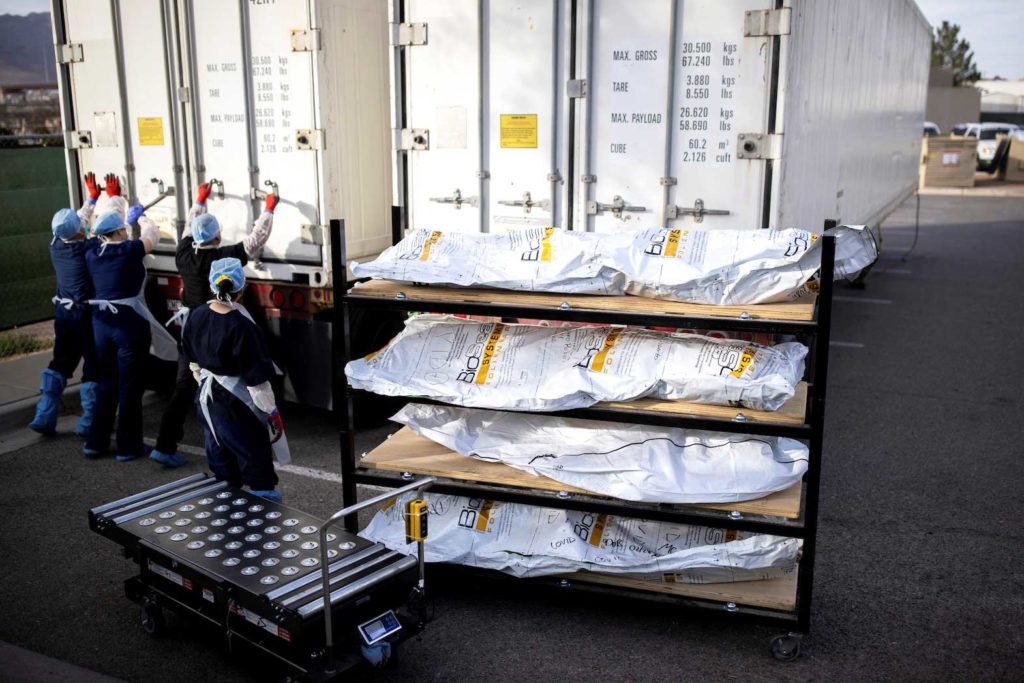 El Paso County Medical Examiner's Office staff lock-up the mobile morgues before moving bodies that are in bags labeled "Covid" from refrigerated trailers into the morgue office amid the coronavirus disease (COVID-19) outbreak, in El Paso, Texas, U.S. November 23, 2020. REUTERS/Ivan Pierre Aguirre