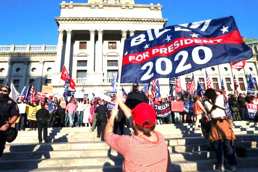  Supporters of U.S. President Donald Trump rally as a supporter of Democratic presidential nominee Joe Biden celebrates outside the State Capitol building after news media declared Biden to be the winner of the 2020 U.S. presidential election. REUTERS FILE