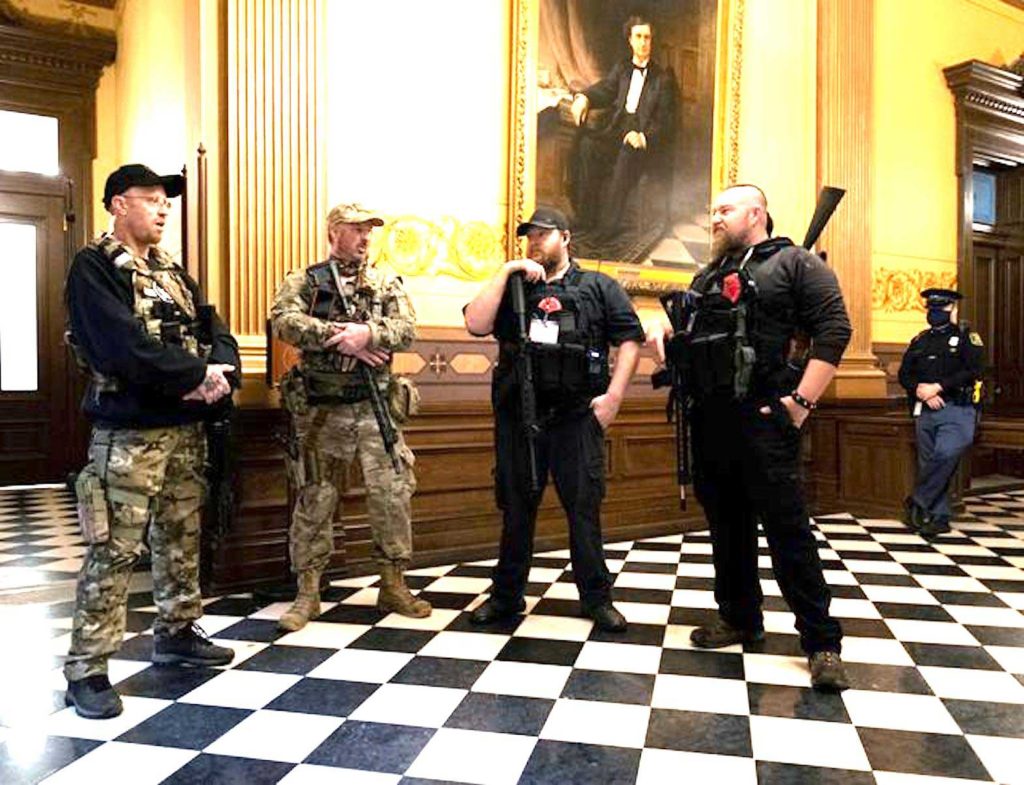 In this file photo, members of an armed group stand near the doors to the chamber in the capitol building before the vote on the extension of Governor Gretchen Whitmer's emergency declaration/stay-at-home order due to the coronavirus disease (COVID-19) outbreak, in Lansing, Michigan, U.S. April 30, 2020. REUTERS/Seth Herald