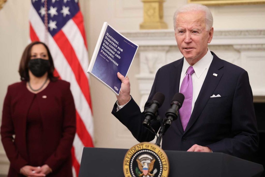 U.S. President Joe Biden speaks about his administration's plans to fight the coronavirus disease (COVID-19) pandemic during a COVID-19 response event as Vice President Kamala Harris listens at the White House in Washington, U.S., January 21, 2021. REUTERS/Jonathan Ernst