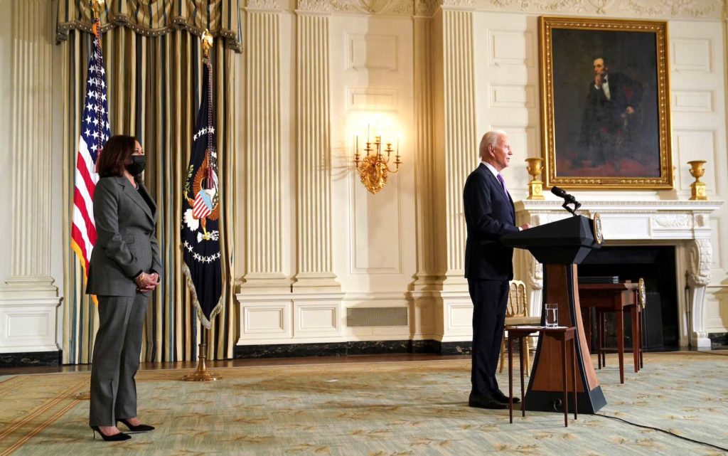  In front of a painting of Abraham Lincoln, U.S. President Joe Biden speaks about his racial equity agenda as Vice President Kamala Harris stands by at the State Dining Room of the White House in Washington, U.S., January 26, 2021. REUTERS/Kevin Lamarque