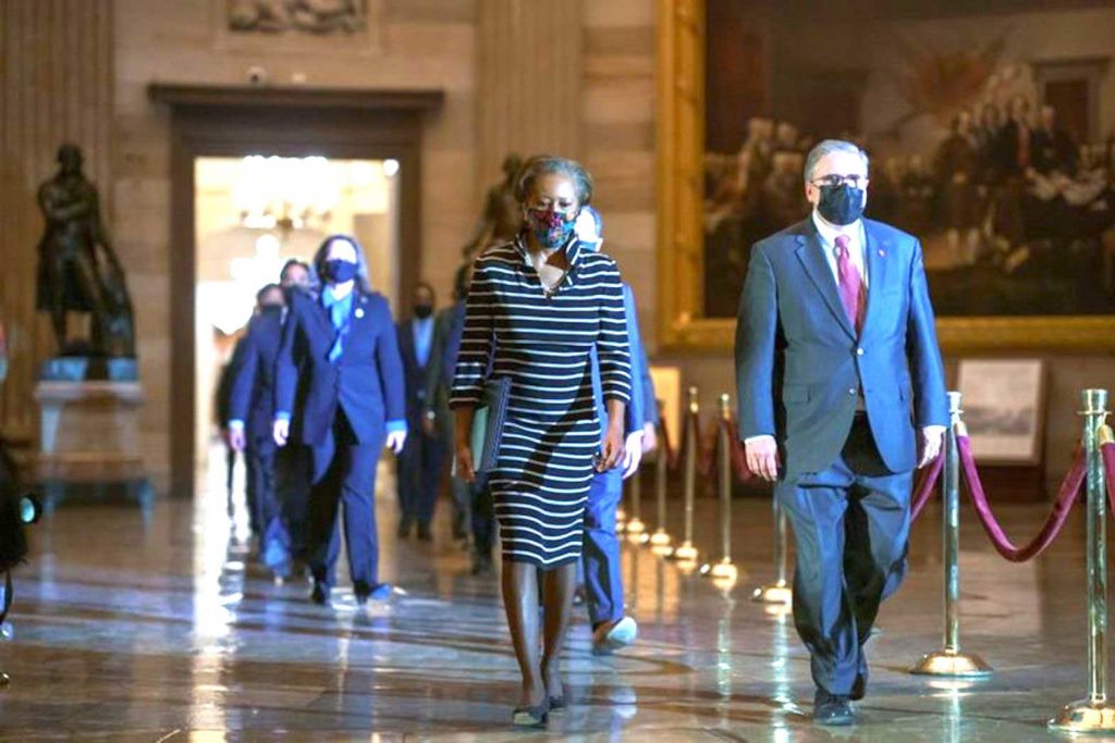 Clerk of the House Cheryl Johnson along with House Sergeant-at-Arms Tim Blodgett lead the Democratic House impeachment managers as they walk through the Statuary Hall on Capitol Hill to deliver to the Senate the article of impeachment alleging incitement of insurrection against former President Donald Trump, in Washington, January 25, 2021. J. Scott Applewhite/Pool via REUTERS