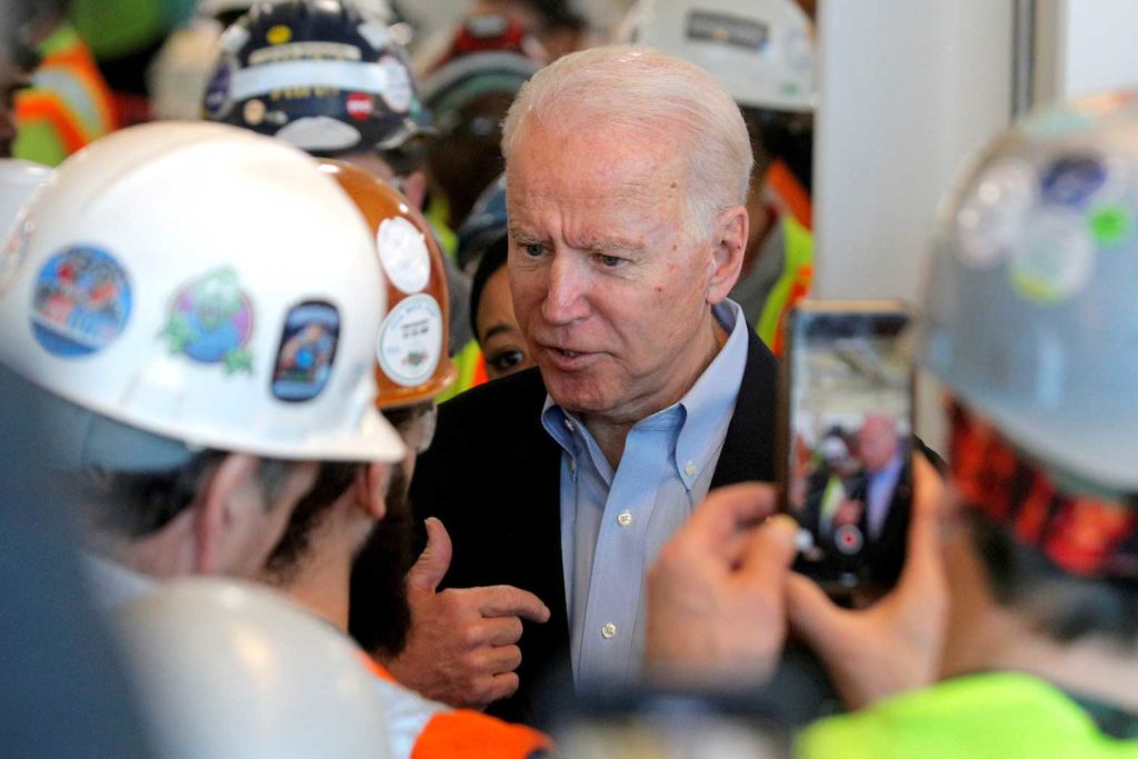 Democratic U.S. presidential candidate Joe Biden talks with a worker at the FCA (Fiat Chrysler Automobiles) Mack Assembly plant in Detroit, Michigan, U.S., March 10, 2020. REUTERS/Brendan McDermid/File Photo