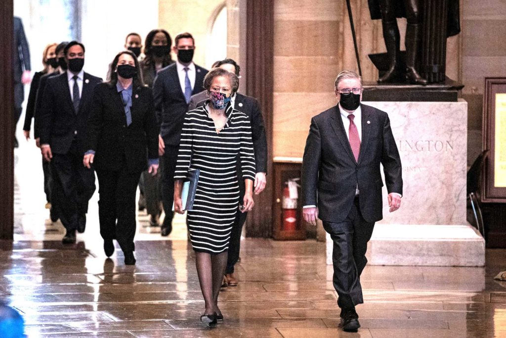  House impeachment managers led by Cheryl Johnson, clerk of the House of Representatives; and Timothy Blodgett, acting sergeant at Arms of the House, arrive to deliver an article of impeachment against former President Donald Trump to the Senate for trial on accusations of inciting the deadly January 6 attack on the Capitol, at the Capitol building in Washington, U.S., January 25, 2021. REUTERS/Al Drago/File Photo