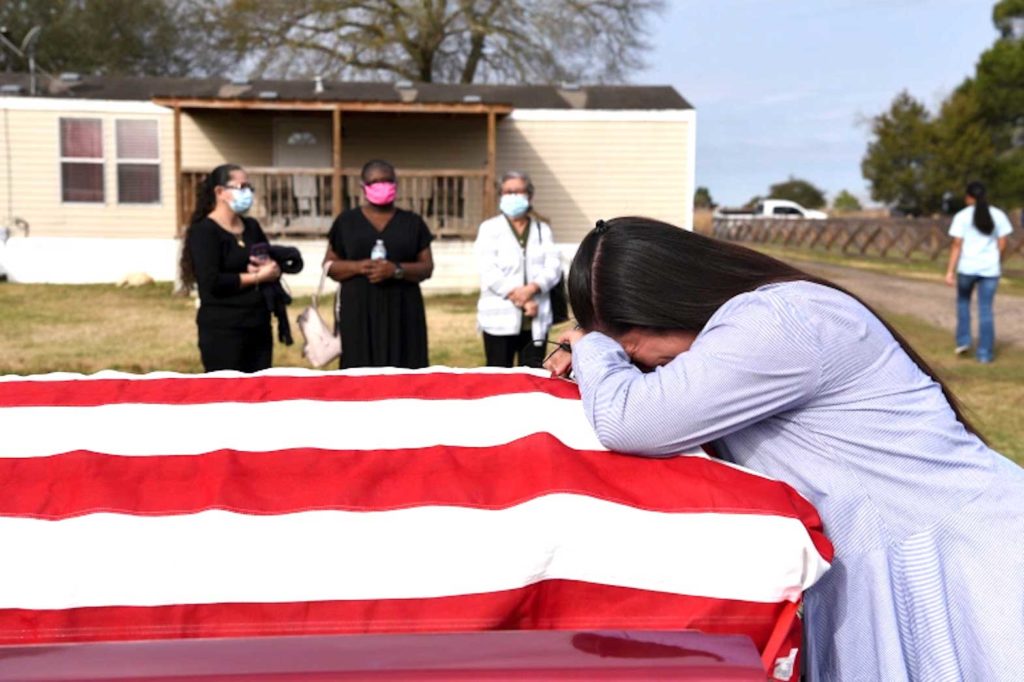  Lila Blanks reacts next to the coffin of her husband, Gregory Blanks, 50, who died from complications from COVID-19, before his funeral in San Felipe, Texas, on January 26 [File: Callaghan O'Hare/Reuters]