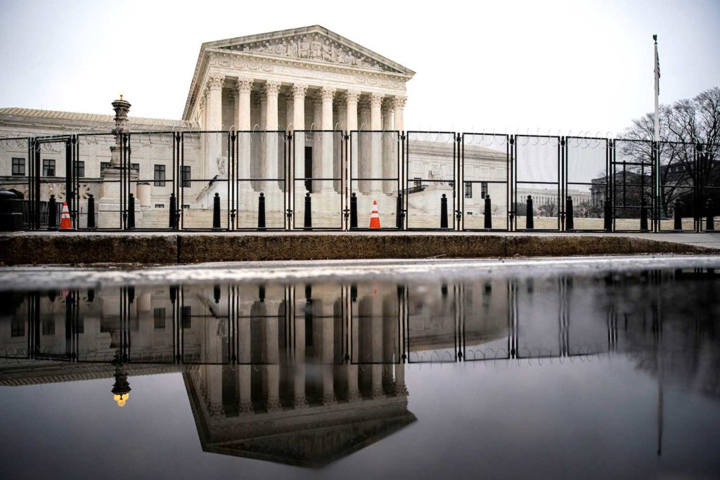  Barbed wire and security fencing surrounds the U.S. Supreme Court in Washington, U.S., January 26, 2021. REUTERS/Al Drago/File Photo