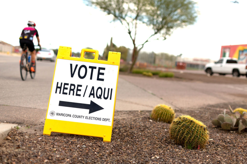 A sign points voters to a voting center for the Democratic primary in Sun City, Arizona, U.S., March 17, 2020. REUTERS/Cheney Orr/File Photo