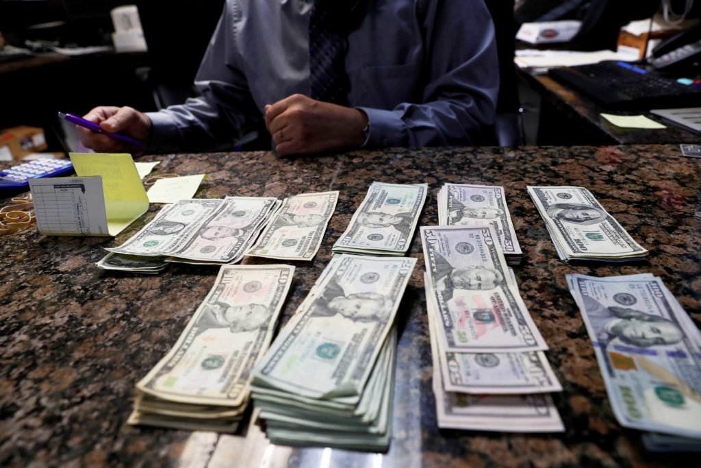 Carlos Gonzalez, managing partner of the Oz Ladies' and Gentlemen's Nightclub, counts money ahead of the Tampa Bay area weekend NFL' Super Bowl LV amid the ongoing spread of the coronavirus disease (COVID-19) at in Clearwater, Florida, February 5, 2021. REUTERS/Shannon Stapleton/File Photo