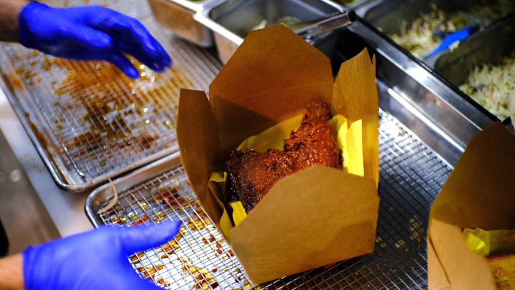 An order of a Love Burn's Hot Chicken Leg being boxed up. INQUIRER/ Migiuel Carrion