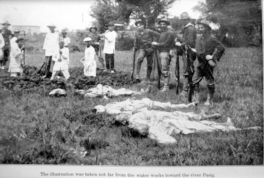 U.S. troops posing before dead Filipino "insurrectos."