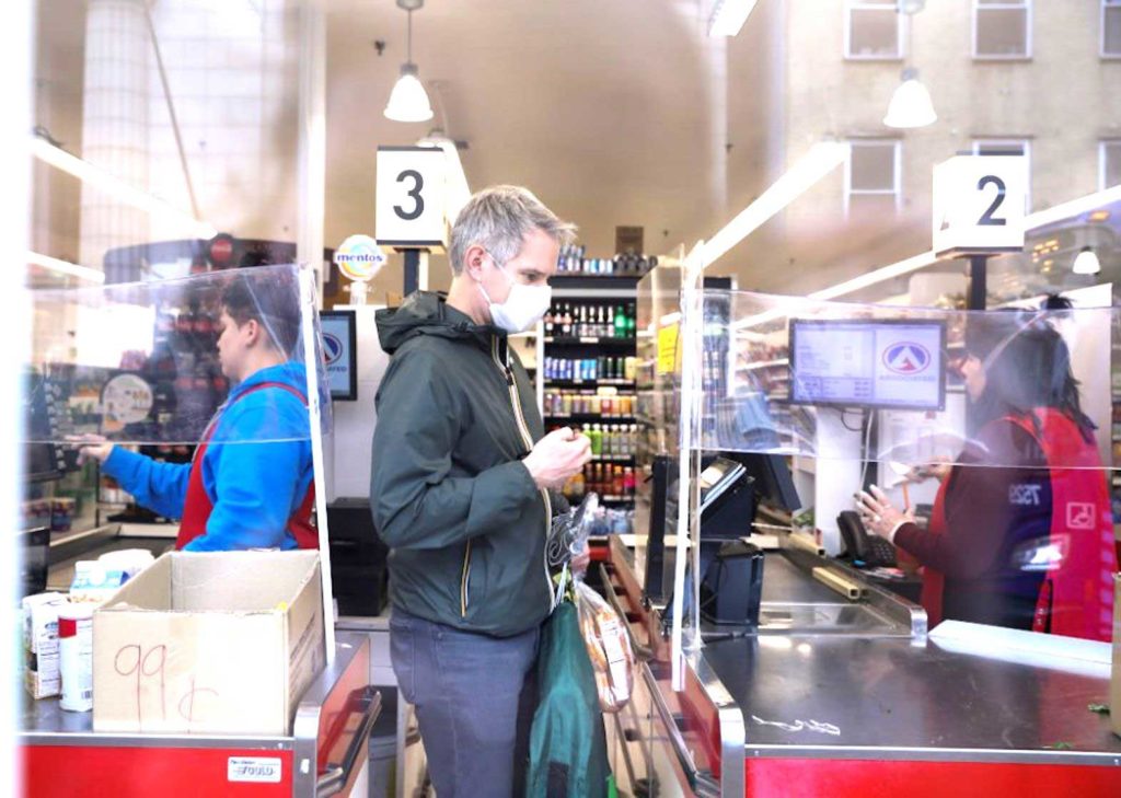  A man in New York City picks up an item at the grocery store March 28, 2020, during the coronavirus pandemic. (CNS/Reuters/Caitlin Ochs)