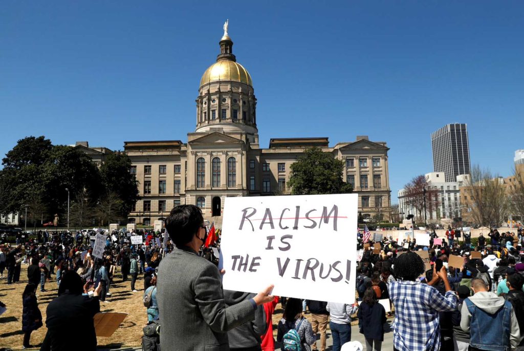People hold placards during a "Stop Asian Hate" rally, following the deadly shootings, in Atlanta, Georgia, U.S., March 20, 2021. REUTERS/Shannon Stapleton