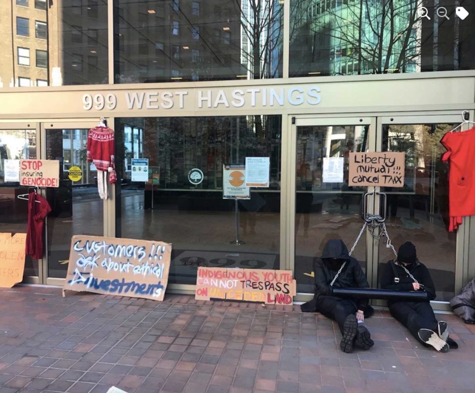 Protesters were arrested at an action in front of the offices of financial institutions involved with TMX. Two protesters chained themselves to the door. (Photo: Youn Bert, Facebook)
