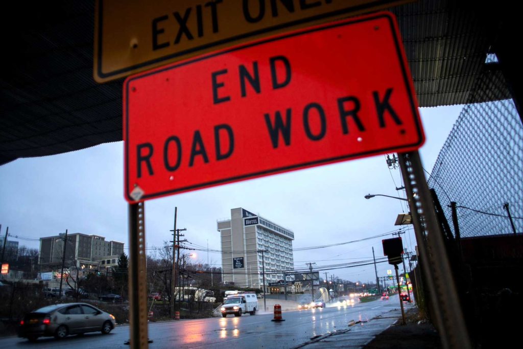 Cars drive along the NJ 495 route while road work signs are seen on the roadside, in Union City, New Jersey, U.S. March 31, 2021. REUTERS/Eduardo Munoz