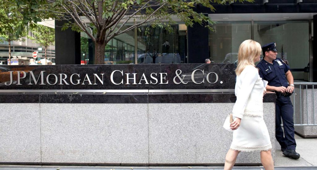 A woman walks past JPMorgan Chase & Co's international headquarters on Park Avenue in New York July 13, 2012. REUTERS/Andrew Burton (UNITED STATES - Tags: BUSINESS LOGO CRIME LAW)/File Photo