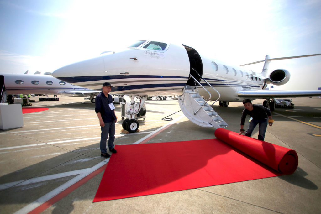 Workers prepare a red carpet in front a Gulfstream aircraft in a file photo. REUTERS/Aly Song
