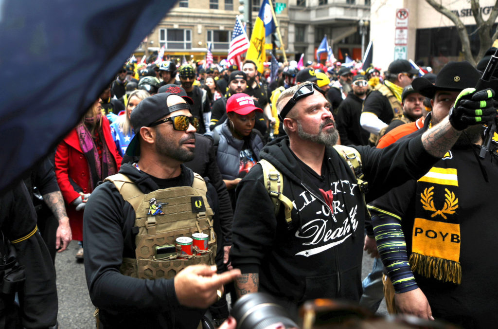 Proud Boys members Enrique Tarrio, left, and Joe Biggs march during a December 12, 2020 protest in Washington, D.C. Tarrio was later arrested for acts committed at the protest and Biggs was later arrested for his involvement in the storming of the U.S. Capitol building in Washington. D.C., U.S. REUTERS/Jim Urquhart/File Photo